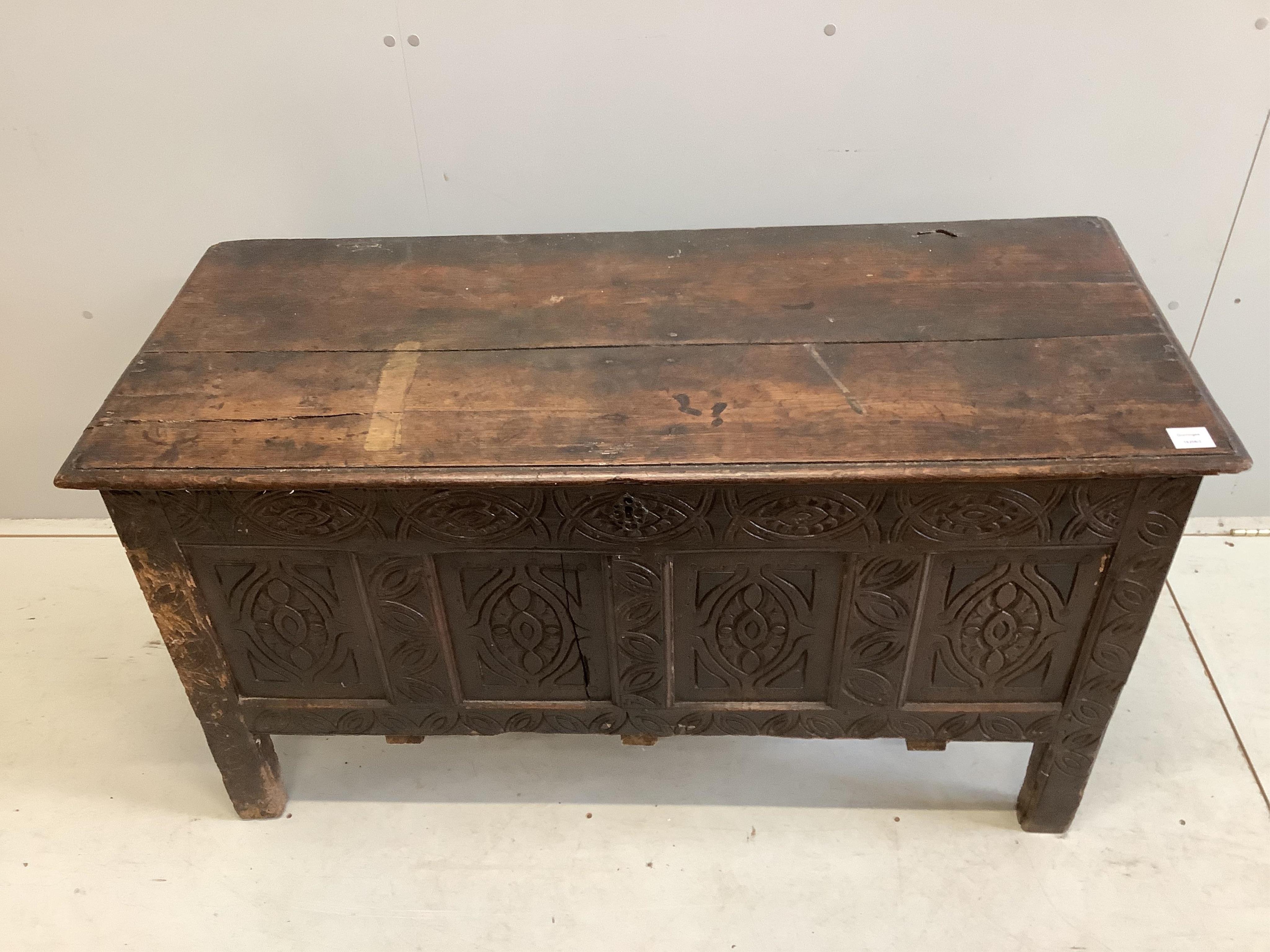 An 18th century carved oak coffer, width 125cm, depth 53cm, height 68cm. Condition - poor